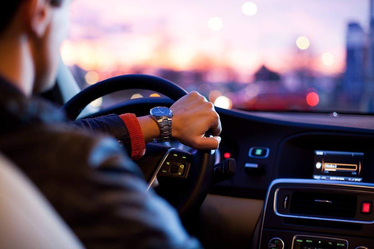 Car driving on open highway during a road trip at sunset